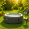 Premium inflatable hot tub bubbling in lush green backyard with vibrant towels, plants, and golden sunlight